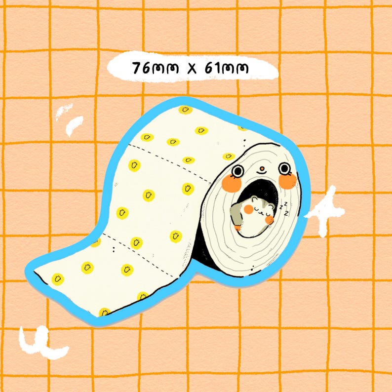 May include: A white toilet roll with yellow dots and a blue border. A small hamster is sleeping inside the roll. The text "76mm x 61mm" is written above the roll.