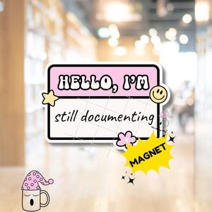 May include: A rectangular name tag magnet with a pink top border and white background. The text reads HELLO, I'M in bold black letters and still documenting in a handwritten script. It features a yellow star, a smiley face, and a pink flower.