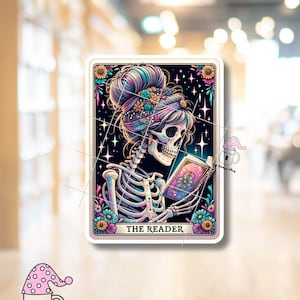 May include: A tarot card illustration featuring a skeleton with a floral crown reading a book with a starry background. The card is titled "THE READER".