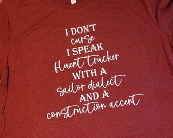 Può includere: T-shirt bordeaux a girocollo con testo bianco. Il testo recita: "I DON'T curse I SPEAK Huent trucker WITH A Sailor dialect AND A construction accent."