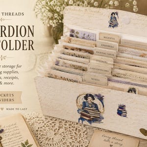 May include: Accordion file folder with 17 pockets and 16 dividers. The handmade storage unit is designed for journaling supplies, ephemera, receipts, and cards. The file folder is white with vintage-style illustrations and text labels.