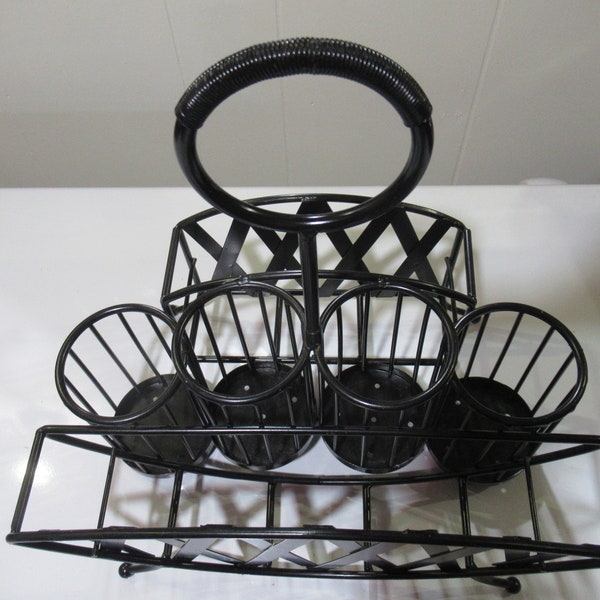 Wrought iron basket for utensils and dishes.