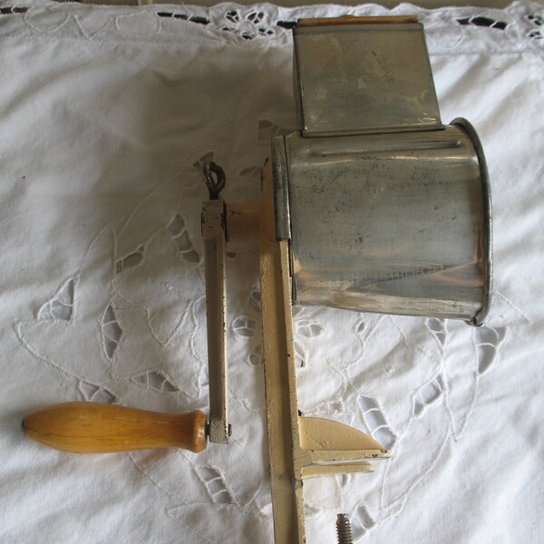 Antique walnut mill, almond, cast iron cheese grater, hand straps for fixing.