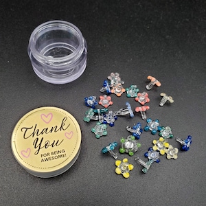 May include: A small, clear glass jar with a gold lid that says "Thank You for being awesome!" with pink hearts. The jar is filled with colorful glass flower-shaped bowl pieces.