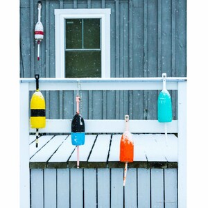 5 Buoys in snow at Carter&#39;s Wharf in Boothbay Harbor, Maine. Photograph printed on canvas.
