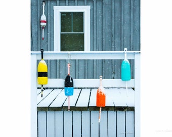 5 Buoys in snow at Carter's Wharf in Boothbay Harbor, Maine. Photograph printed on canvas.