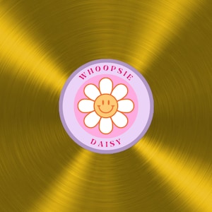 May include: A gold record with a purple and pink sticker that says "WHOOPSIE DAISY" with a yellow smiley face in a white daisy.