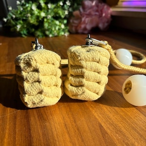 May include: Two yellow rope poi with silver swivels and a white rope with white poi balls.