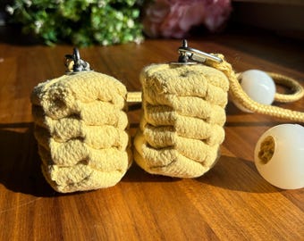 May include: Two yellow rope poi with silver swivels and a white rope with white poi balls.
