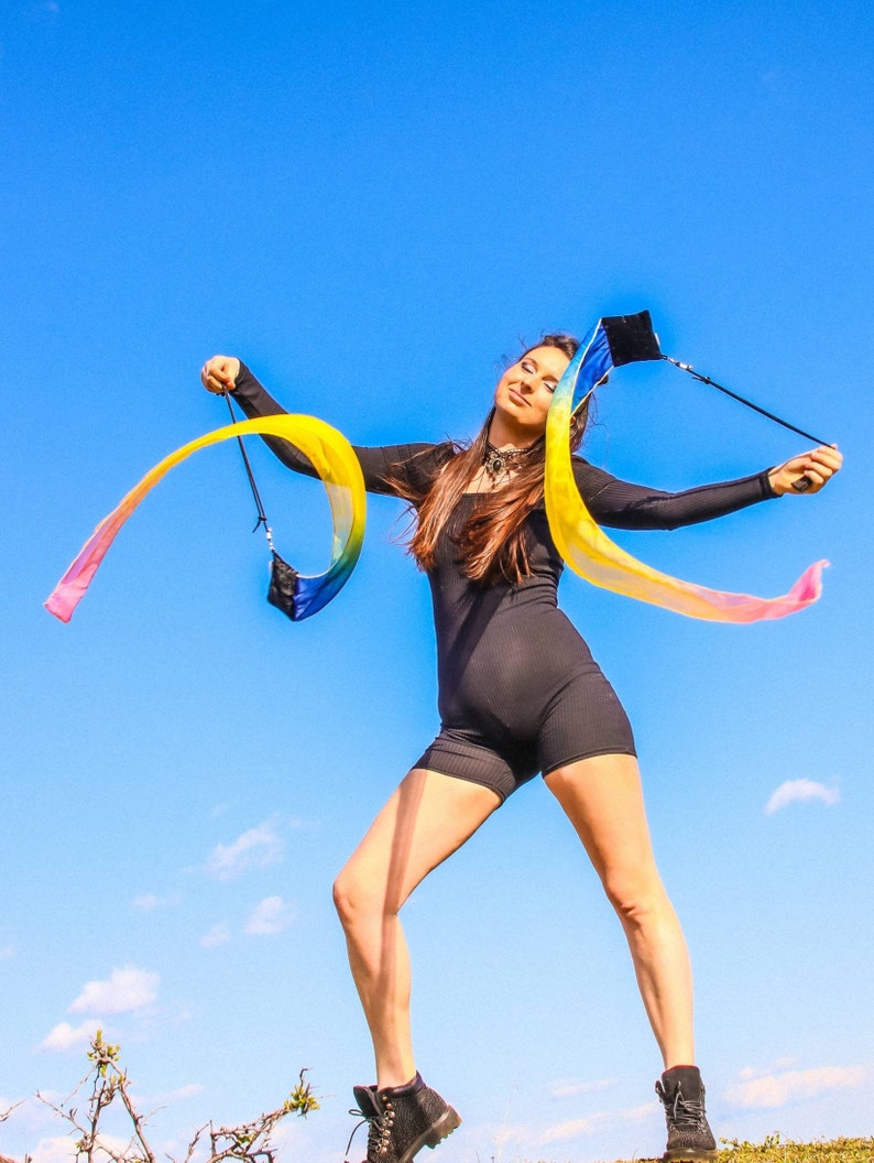 Handmade wind poi with colorful soft ribbon tails flowing in motion for flow arts and dance