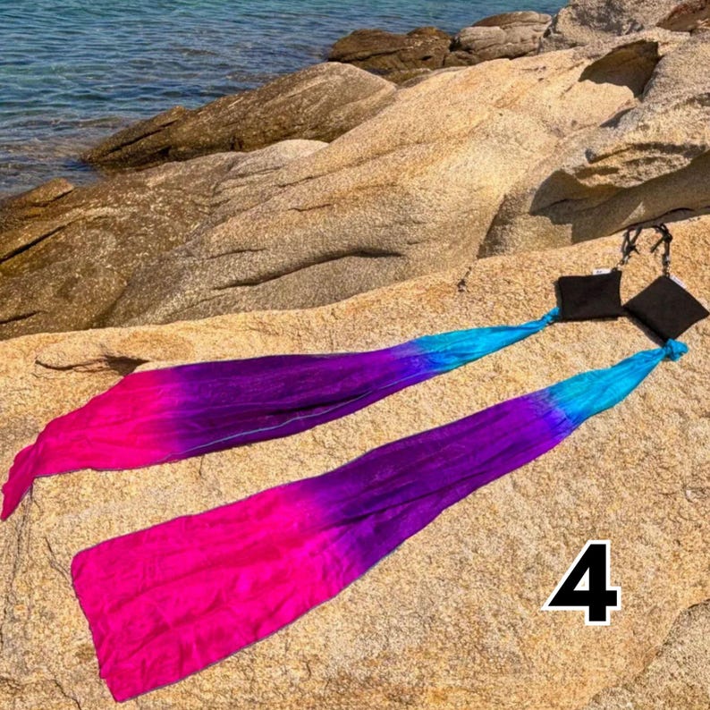 Wind poi pair in motion — handmade lightweight fabric prop for dance and flow arts