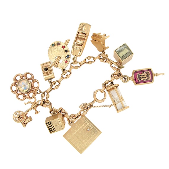 14K gold charms bracelet with 11 charms, circa 195