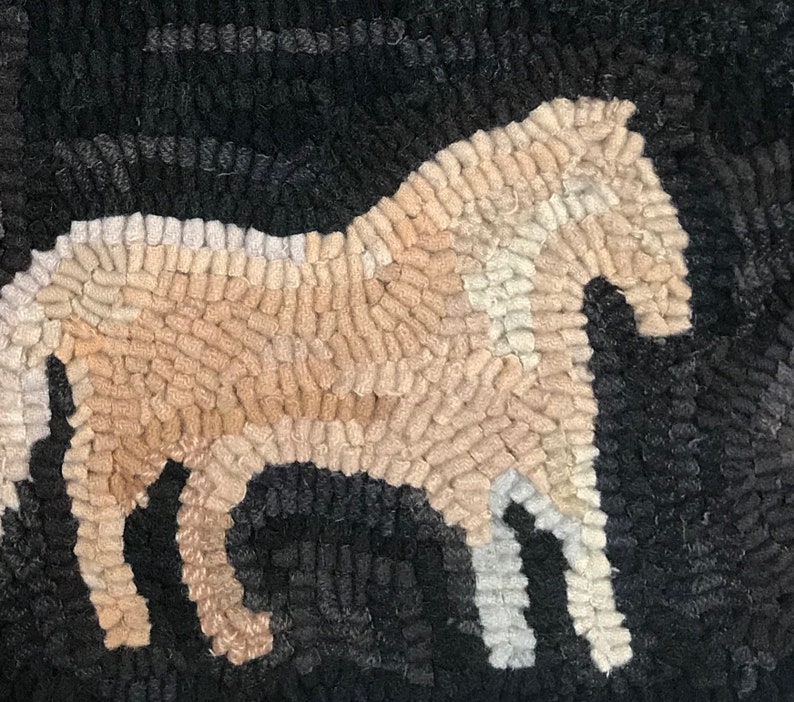 May include: A hand-hooked rug featuring a horse silhouette. The horse is rendered in shades of tan, cream, and white against a dark gray and black background. The rug's texture is visible, showcasing the looped yarn construction.