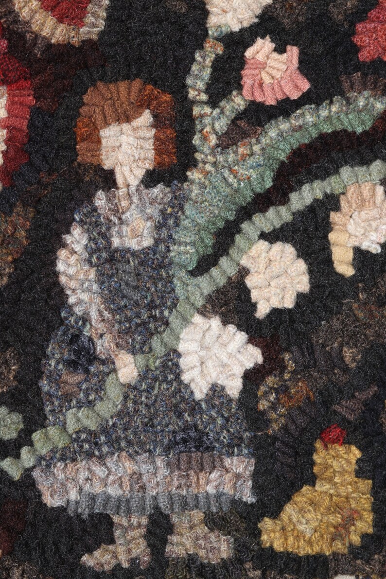 May include: A detailed textile art piece featuring a figure holding a floral branch. The figure is depicted in a dark blue dress with a white collar and brown hair. The background is dark with accents of red, pink, and beige.