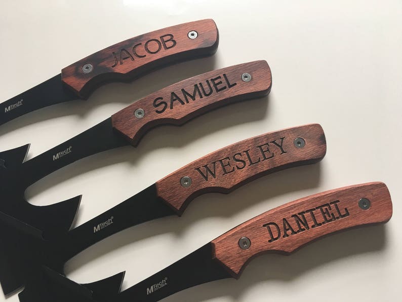 May include: Four black handled knives with wooden handles. Each handle has a different name engraved on it: Jacob, Samuel, Wesley, and Daniel.