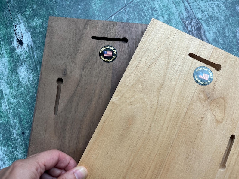 May include: Two wooden plaques, one dark brown and one light brown, with keyhole slots for hanging. Each plaque has a circular sticker with an American flag and the text "PREMIUM WALNUT MADE IN U.S.A."