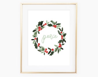 May include: A printable art print featuring a watercolor wreath with green leaves and red berries. The wreath surrounds the word "peace" in a light green color.