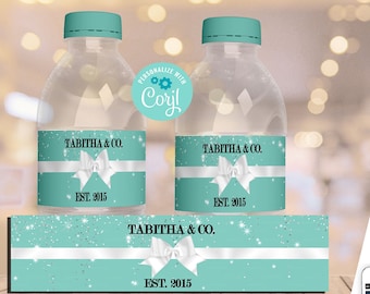 May include: Two clear plastic water bottles with teal caps and custom labels featuring a white ribbon graphic, silver glitter accents, and the text Tabitha & Co. Est. 2015. The labels measure 20.32 cm by 5.08 cm and are shown on a wooden surface.