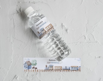 May include: Water bottle label with a blue and brown train design. The label says "Jaxson's 2nd Birthday".