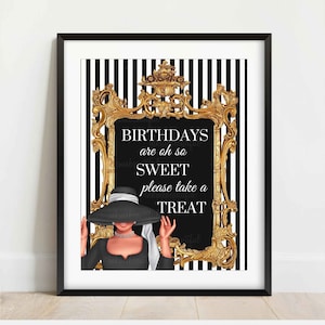 May include: A framed print with a black and white striped background. The print features a gold ornate frame around a black background with the text "BIRTHDAYS are oh so SWEET please take a TREAT". A woman in a black hat is depicted.