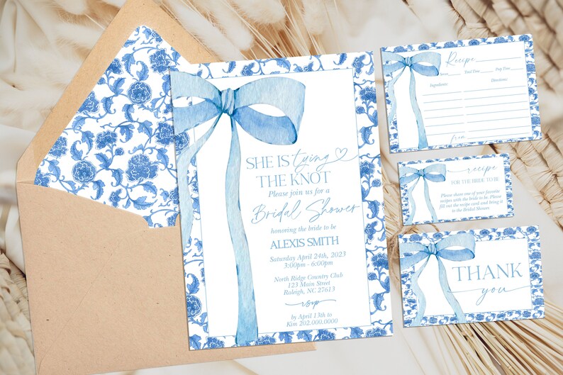 May include: Blue and white floral patterned bridal shower invitation with a blue ribbon bow. The invitation says "She is tying the knot" and includes the bride's name, date, time, and location. There are also two smaller cards, one for a recipe and one that says "Thank you".