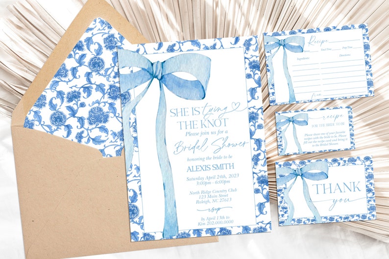 May include: Blue and white floral patterned invitation suite for a bridal shower. The invitation features a blue watercolor bow and the text "She is tying the knot. Please join us for a Bridal Shower honoring the bride to be Alexis Smith. Saturday April 24th, 2023 3:00pm - 6:00pm North Ridge Country Club 127 Main Street Raleigh, NC 27613 RSVP by April 17th to 202.000.0000". There are also cards for a recipe and a thank you.