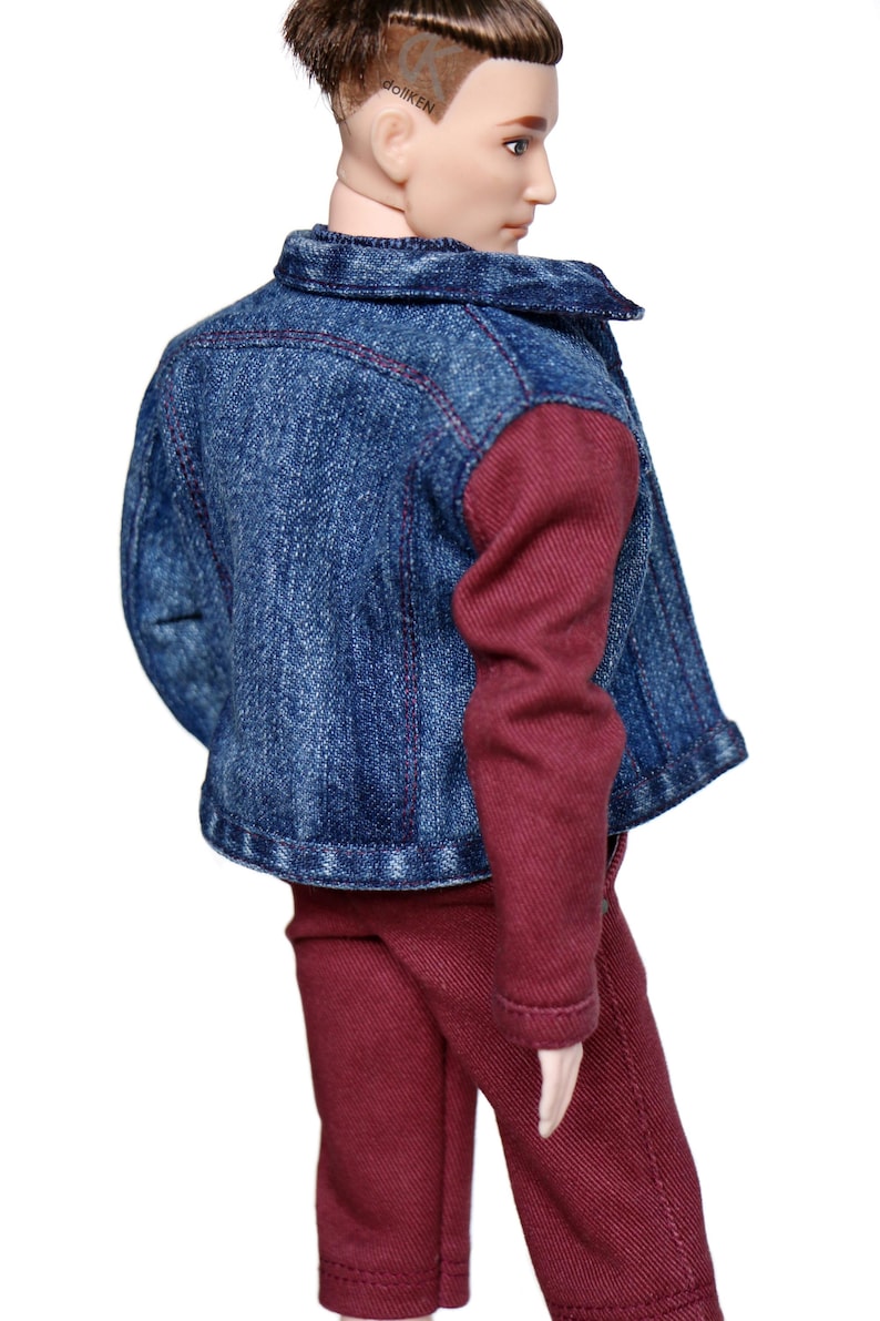 May include: A denim jacket with maroon sleeves and maroon pants. The jacket has a button closure and a collar.
