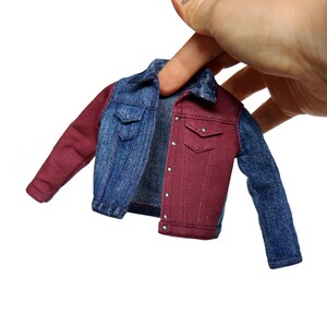 May include: A denim jacket with one red sleeve and one blue sleeve. The jacket is unbuttoned and has a pocket on each side.