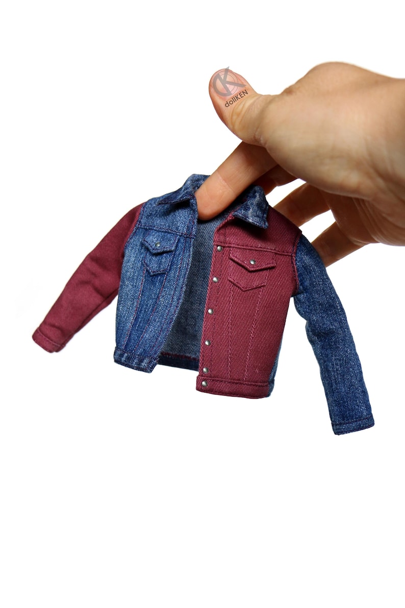 May include: A denim jacket with one red sleeve and one blue sleeve. The jacket is unbuttoned and has a pocket on each side.