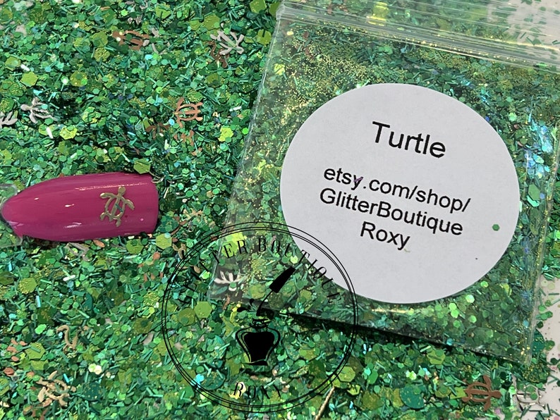 May include: Green glitter with small turtle charms and a label that reads "Turtle etsy.com/shop/GlitterBoutique Roxy".