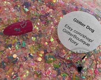 May include: Pink, iridescent glitter with small, colorful dog shapes. The glitter is in a clear plastic bag with a white circle sticker that says "Glitter Dog Etsy.com/shop/GlitterBoutique Roxy".