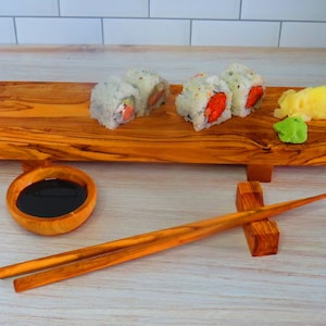 Set Sushi. Bamboo mat, chopsticks, wasabi, soy sauce, nigiri, rolls and  wood serving board. By MoreVector