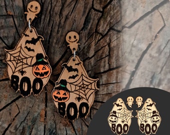May include: Wooden Halloween earrings featuring a ghost, spiderweb, bat, and jack-o'-lantern design. The word "BOO" is prominently displayed. The earrings are light brown with black accents. The image also includes a digital file graphic with the text "Digital Files SVG .PDF .DXF".