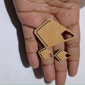 May include: Three wooden shapes with rounded edges and holes around the perimeter. The shapes are a large diamond, a smaller diamond, and a small triangle. The shapes are light brown and have a wood grain pattern.