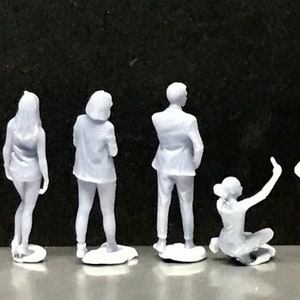 May include: Set of six white plastic figurines of people in various poses. The figurines are about 3 inches tall and are made of a smooth, matte plastic.
