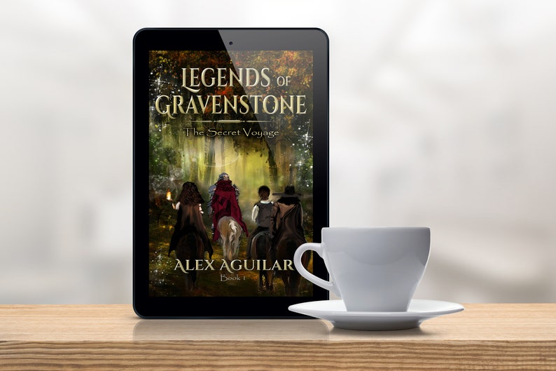 May include: A tablet computer displaying the cover of a fantasy novel titled "Legends of Gravenstone: The Secret Voyage" by Alex Aguilar. The cover features a group of people on horseback riding through a forest.