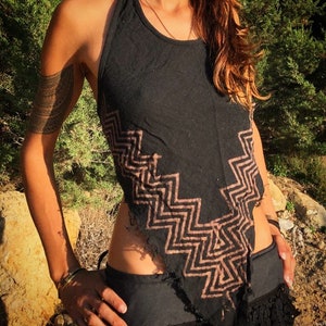 May include: A black halter top with a brown zig-zag pattern. The top is ripped and frayed at the edges.