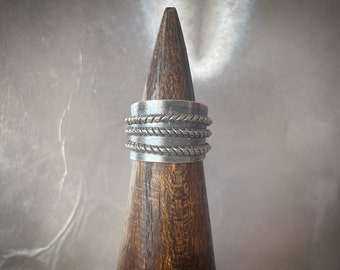 Rope wrapped on dark base silver ring