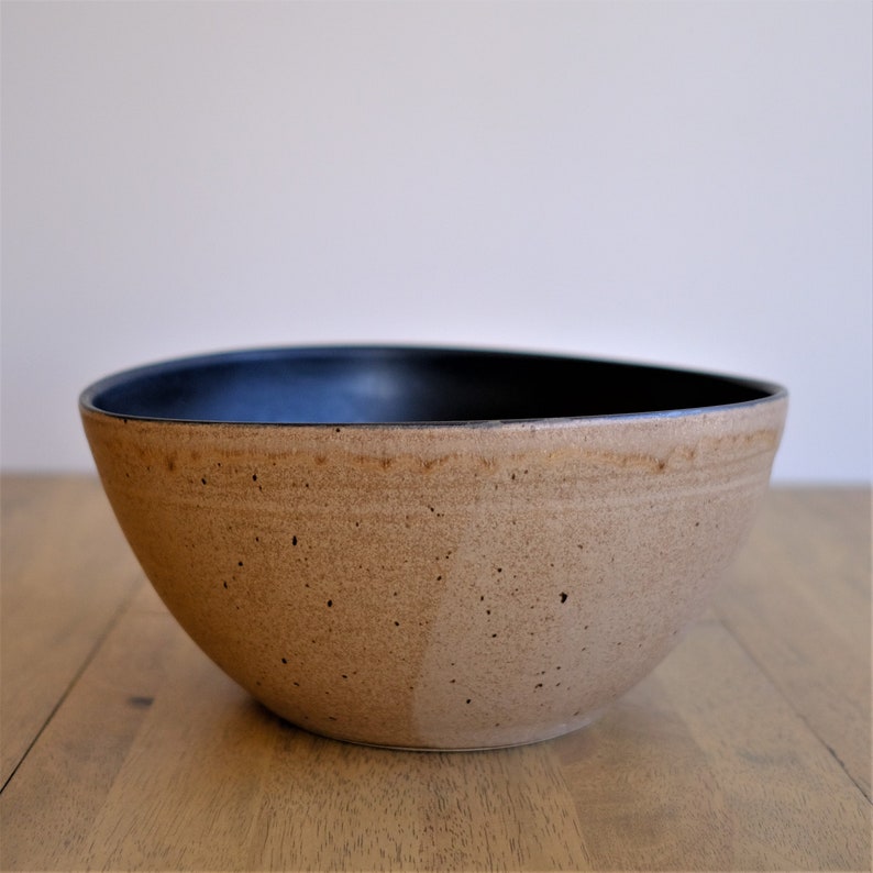 Beautiful large handmade stoneware serving bowl made by Dustin Johnston in a contemporary style with black glaze on the inside to showcase whatever is being served in it and a Sand organic glaze on the outside creating a wonderful contrast.