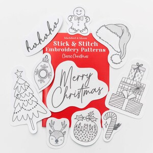 May include: A set of nine black and white embroidery patterns featuring classic Christmas designs, including a Christmas tree, a gingerbread man, a stocking, a present, a candy cane, a Christmas pudding, a reindeer, an ornament, and the words "Merry Christmas".