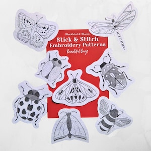 May include: A collection of stick and stitch embroidery patterns featuring various bug designs, including a butterfly, dragonfly, beetles, and a bee. The patterns are displayed on a red background with the text "Blackbird & Bloom Stick & Stitch Embroidery Patterns Beautiful Bugs."