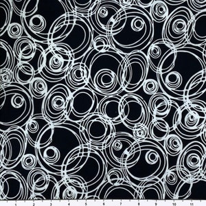 May include: Black fabric with a white abstract pattern of overlapping circles and swirls.