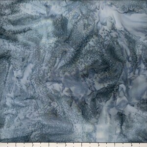 May include: A blue and white fabric with a mottled, tie-dye pattern. The fabric has a soft, textured feel.