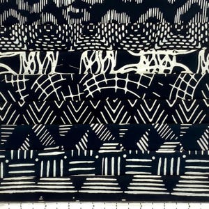 May include: A fabric sample featuring a repeating pattern in black and white. The design includes various geometric shapes, such as zigzags, chevrons, and grid-like structures. The fabric is likely used for clothing or home decor.