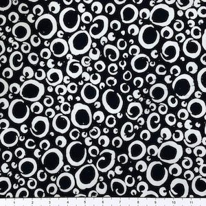 May include: Black fabric with a white pattern of circles and swirls. The circles are of varying sizes and are randomly placed.