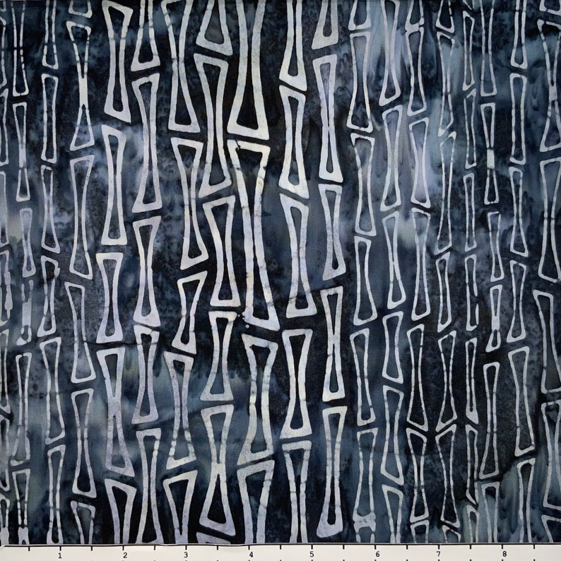 May include: A dark blue fabric with a white geometric pattern of repeating shapes. The pattern resembles a series of vertical lines with a slight wavy effect.