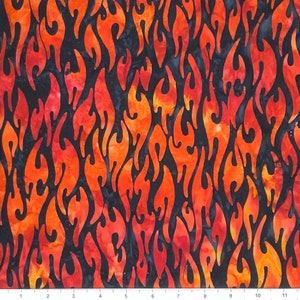 May include: A black fabric with a repeating pattern of orange and red flames. The flames are stylized and have a batik-like appearance.