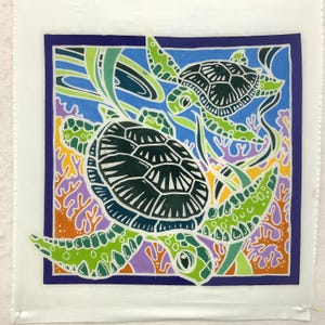 May include: A colorful hand-painted fabric panel featuring two sea turtles swimming in a blue ocean with coral reefs. The turtles are black and green with white accents. The coral reefs are orange, purple, and green.