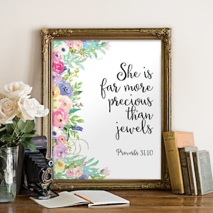 May include: A framed print with a watercolor floral border and the quote "She is far more precious than jewels Proverbs 31:10".