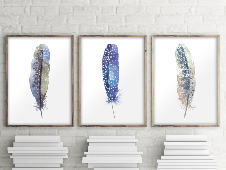 May include: Three watercolor paintings of blue and brown feathers with white spots on a white background.